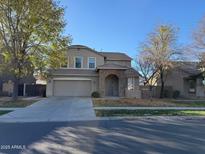 Two-story house with a large front yard and attached garage at 4073 E Vaughn Ave, Gilbert, AZ 85234
