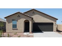 One-story house with a two-car garage and desert landscaping at 5717 W Willow Ridge Dr, Laveen, AZ 85339