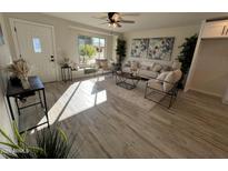 Bright living room with hardwood floors, comfy seating, and large windows at 8448 E Cambridge Ave, Scottsdale, AZ 85257