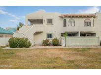 Condo building with Spanish-style architecture, private entrance, and grassy area at 850 S River Dr # 1092, Tempe, AZ 85281