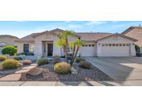 Single-story home with desert landscaping and two-car garage at 8729 W Tonopah Dr, Peoria, AZ 85382