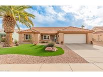 Single-story home with a landscaped front yard, featuring artificial turf and desert landscaping at 15225 W Via Manana Dr, Sun City West, AZ 85375