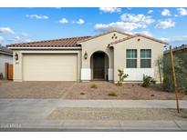 One-story home with neutral exterior, two-car garage, and landscaped front yard at 16780 W Cameron Dr, Surprise, AZ 85388