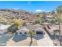 Aerial view of single story home with desert landscape and mountain views at 1819 W Evans Dr, Phoenix, AZ 85023