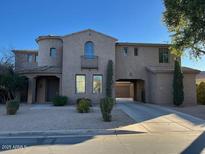 Two-story house with arched entryway and courtyard at 20391 E Via Del Oro Dr, Queen Creek, AZ 85142