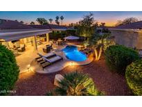 Inviting backyard oasis featuring a sparkling pool and patio area at 22012 N Arrellaga Dr, Sun City West, AZ 85375