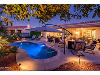 Unwind by the pool with comfortable lounge chairs and an umbrella at 22012 N Arrellaga Dr, Sun City West, AZ 85375