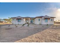 Single-story home with stone accents and a tile roof.Landscaped yard with walkway at 22859 W Euclid Ave, Buckeye, AZ 85326