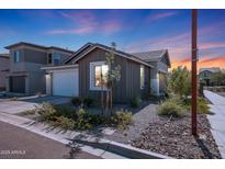 Single-story home with attached garage, landscaping, and a modern exterior design at 4802 S Duffy --, Mesa, AZ 85212