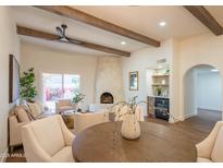 Bright living room with fireplace, high ceilings, and built-in bar at 6425 N 79Th St, Scottsdale, AZ 85250