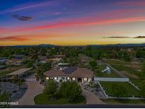 Aerial view of a house with solar panels, a large backyard, and mountain views at 715 S Cactus Wren St, Gilbert, AZ 85296