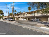 Building exterior showcasing ample parking and a well-maintained landscape at 725 S Power Rd # 214, Mesa, AZ 85206