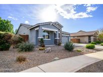 One-story home with gray exterior, stone accents, and landscaped front yard at 7917 W Sierra Vista Dr, Glendale, AZ 85303