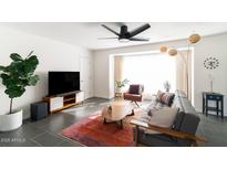 Mid century modern living room with a gray couch and area rug at 908 E Cavalier Dr, Phoenix, AZ 85014