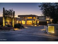 Luxury home with modern architecture, landscaped grounds, and dramatic night lighting at 12308 N 119Th St, Scottsdale, AZ 85259