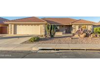 Single-story home with desert landscaping and a two-car garage at 2144 S Yellow Wood Ave, Mesa, AZ 85209