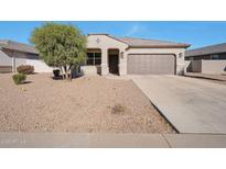 One-story house with desert landscaping and a two-car garage at 36148 W Seville Dr, Maricopa, AZ 85138