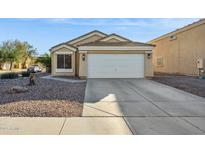 Cute one-story house with a two-car garage and well-maintained landscaping at 36509 W Nina St, Maricopa, AZ 85138