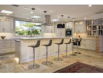 Modern kitchen with large island and stainless steel appliances at 3921 E San Miguel Ave, Paradise Valley, AZ 85253