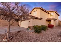 Two-story house with desert landscaping, two-car garage, and neutral color scheme at 403 S 228Th Ln, Buckeye, AZ 85326