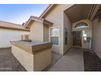 Tan house exterior with a two-car garage and gravel driveway at 4149 W Park Ave, Chandler, AZ 85226