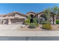 Beautiful desert landscaping surrounds this single-story home with a 3-car garage at 4410 E Robin Ln, Phoenix, AZ 85050