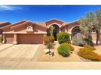 Charming single-story home with a well-maintained front yard and desert landscaping under a bright blue sky at 4410 E Robin Ln, Phoenix, AZ 85050