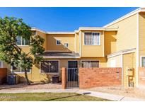 Front view of a yellow two-story townhome with a gated entrance at 510 N Alma School Rd # 158, Mesa, AZ 85201