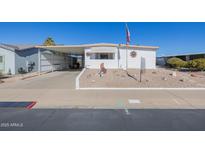 White single-wide manufactured home with carport and landscaped yard at 5646 E Player Pl, Mesa, AZ 85215