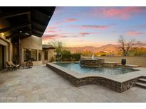 Luxury backyard oasis with a stunning pool, fountain, and mountain views at 8787 E Lost Gold Cir, Gold Canyon, AZ 85118