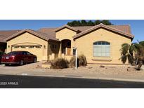 Single-story home with a two-car garage and landscaped front yard at 9758 E Meseto Ave, Mesa, AZ 85209