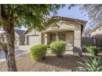 Cute one-story house with a two-car garage and nicely landscaped front yard at 10372 E Raintree Dr, Scottsdale, AZ 85255