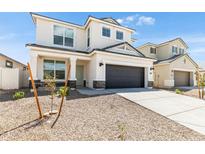 Two-story house with a dark gray garage door and landscaping at 17631 W Sanna St, Waddell, AZ 85355