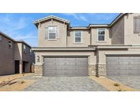 Charming townhome showcasing a two-car garage, a neutral color palette, and a well-manicured front yard at 21028 N 58Th Way, Phoenix, AZ 85054