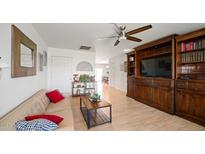 Bright living room features a comfy sofa and built-in shelving at 3737 W Morrow Dr, Glendale, AZ 85308