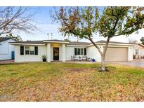 White house with black shutters, landscaping, and a two-car garage at 4030 E Fairmount Ave, Phoenix, AZ 85018