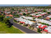 Expansive aerial view of a vibrant community with a mix of single-Gathering homes and lush green landscaping at 7927 E Sage Dr, Scottsdale, AZ 85250