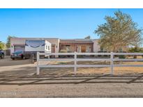 Single story home with RV parking and a white picket fence at 9109 S 220Th Dr, Buckeye, AZ 85326