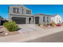 Two-story home with gray exterior, two-car garage, and landscaping at 11054 E Utopia Ave, Mesa, AZ 85212