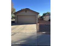 Attached garage with ample space for one vehicle and storage at 12103 W Rosewood Dr, El Mirage, AZ 85335