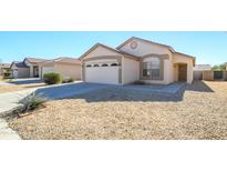 Single-story house with a two-car garage and desert landscaping at 15819 W Crocus Dr, Surprise, AZ 85379