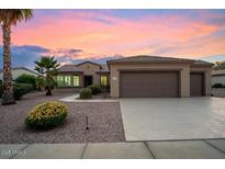 Single-story home with a two-car garage and desert landscaping at 19724 N Jojoba Ct, Surprise, AZ 85374