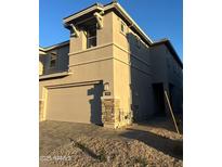 Tan two-story home with attached garage and landscaping at 21011 N 58Th Way, Phoenix, AZ 85054