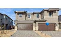 Beautiful two-story home with a three car garage, stone accents, and a well-manicured lawn at 21016 N 58Th Way, Phoenix, AZ 85054