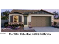 Craftsman style home with two-car garage and landscaping at 22311 W Monona Ln, Surprise, AZ 85387