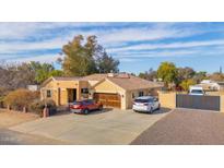 Single-story home with a large driveway and gated entrance at 3848 W Morrow Dr, Glendale, AZ 85308