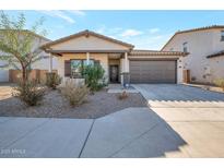 Charming house with attached garage and desert landscaping at 40465 W Chambers Dr, Maricopa, AZ 85138