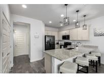 Modern kitchen features granite countertops, stainless steel appliances, and a breakfast bar with seating at 4058 E Erie E St # 103, Gilbert, AZ 85295