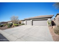 House exterior features a three-car garage and desert landscaping at 42028 N Crooked Stick Rd, Anthem, AZ 85086