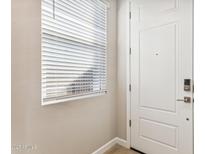 Bright entryway with white door and window blinds at 5819 E Rose Garden Ln, Phoenix, AZ 85054